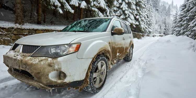 72676715 - 4x4 suv car on a snowy road in the mountains
